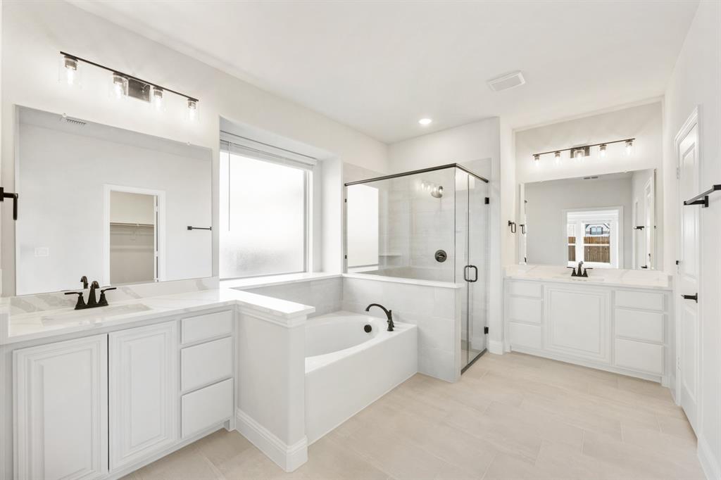 913 Firewood Way Anna, TX 75409 - Photo 23 of 40 a bathroom with a bathtub a sink a mirror a shower and vanity