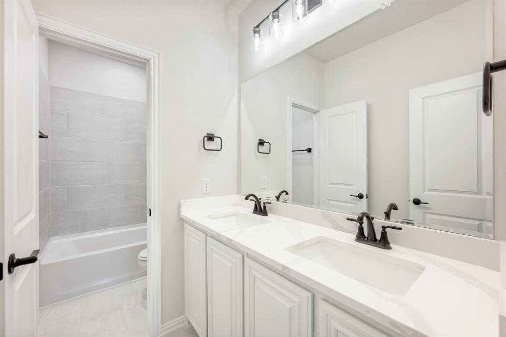 913 Firewood Way Anna, TX 75409 - Photo 33 of 40 a bathroom with a sink a toilet and shower