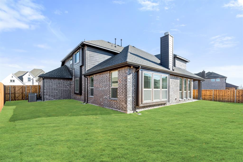 913 Firewood Way Anna, TX 75409 - Photo 38 of 40 a front view of a house with a yard and deck