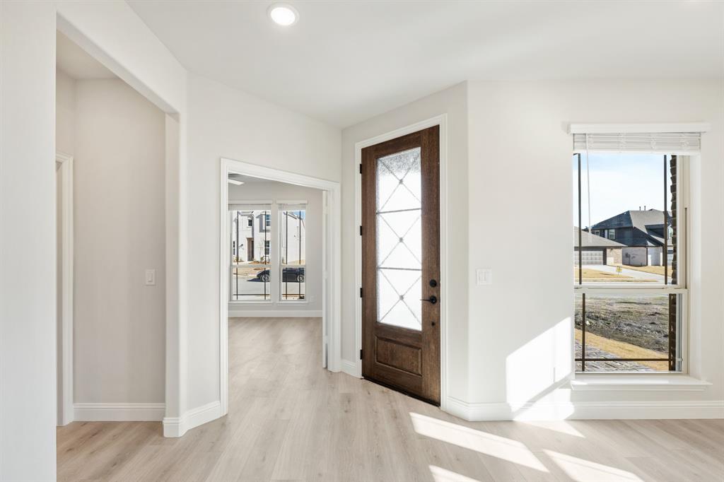 913 Firewood Way Anna, TX 75409 - Photo 5 of 40 a view of a hallway with wooden floor and dining room