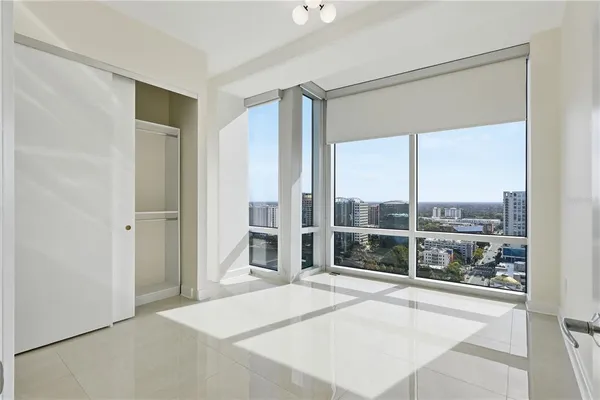 a view of a balcony with a floor to ceiling windows and city view