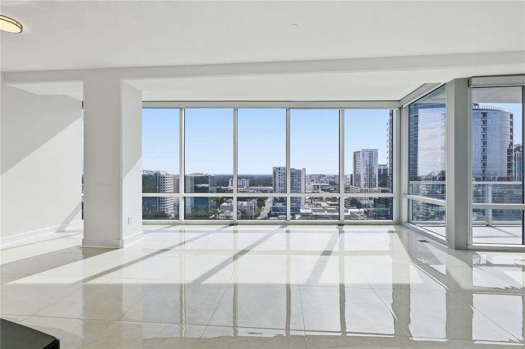 150 East Robinson Street, Unit 2002 Orlando, FL 32801 - Photo 18 of 41 a room with a bed and glass door
