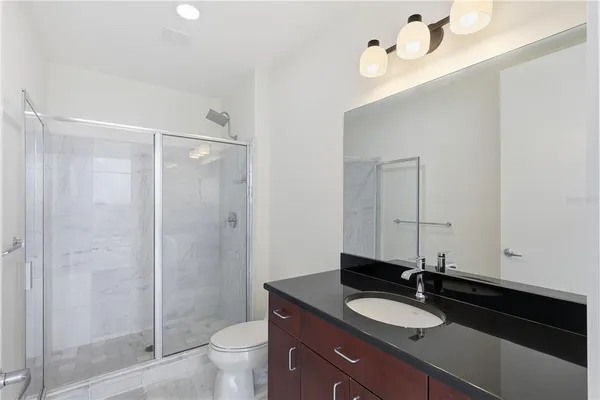 a view of a livingroom with a ceiling fan and window