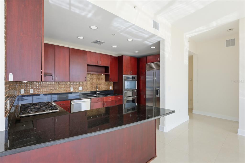 150 East Robinson Street, Unit 2002 Orlando, FL 32801 - Photo 9 of 41 a kitchen with stainless steel appliances granite countertop a stove and a refrigerator