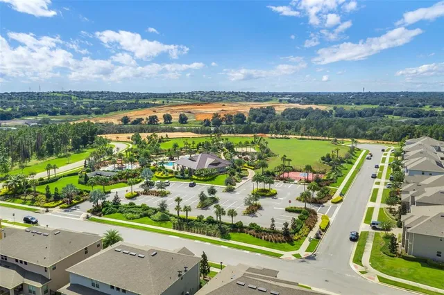 an aerial view of a house with a yard and garden