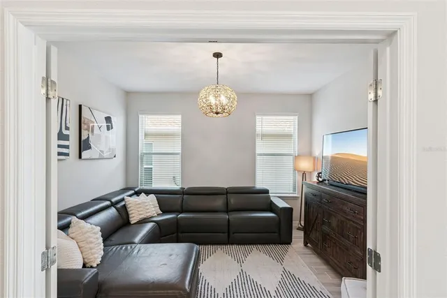 a living room with lots of furniture and view of bedroom