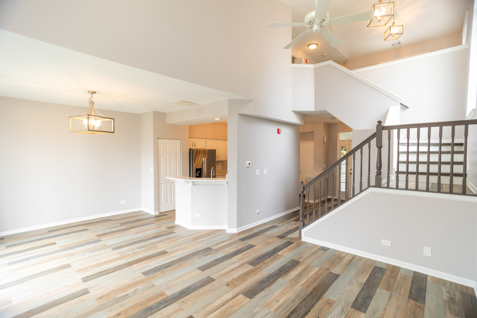 1082 Ripple Ridge Darien, IL 60561 - Photo 6 of 20 a view of a hallway with wooden floor and staircase