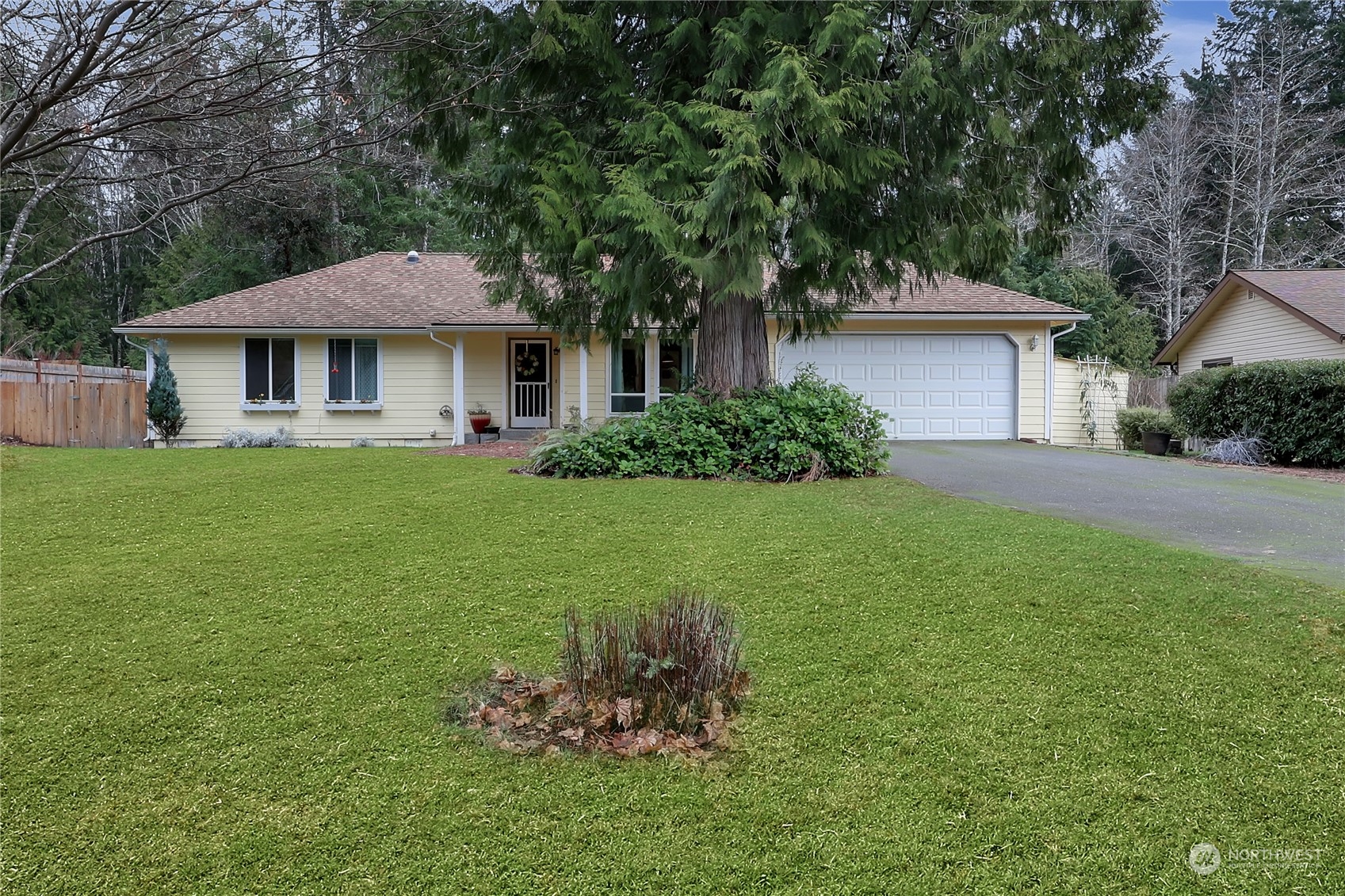 7455 Glacier Ridge Place Southeast Port Orchard, WA 98367 - Photo 1 of 32 a front view of a house with a garden