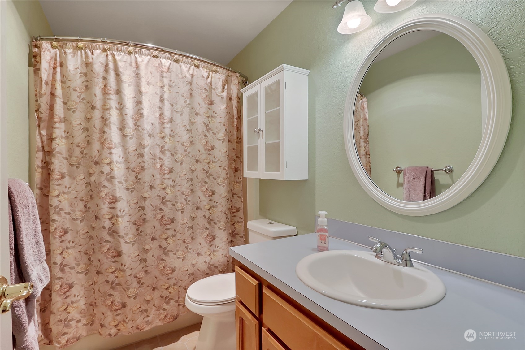 7455 Glacier Ridge Place Southeast Port Orchard, WA 98367 - Photo 19 of 32 a bathroom with a sink a toilet and a mirror