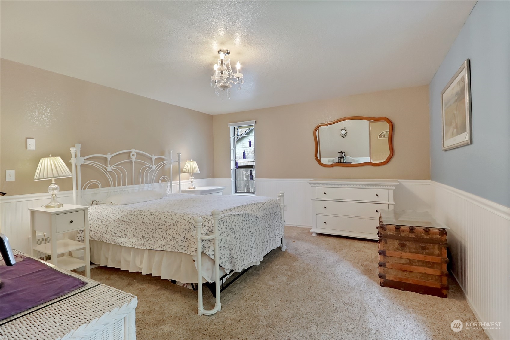 7455 Glacier Ridge Place Southeast Port Orchard, WA 98367 - Photo 20 of 32 a bedroom with a bed a chandelier with dresser and mirror