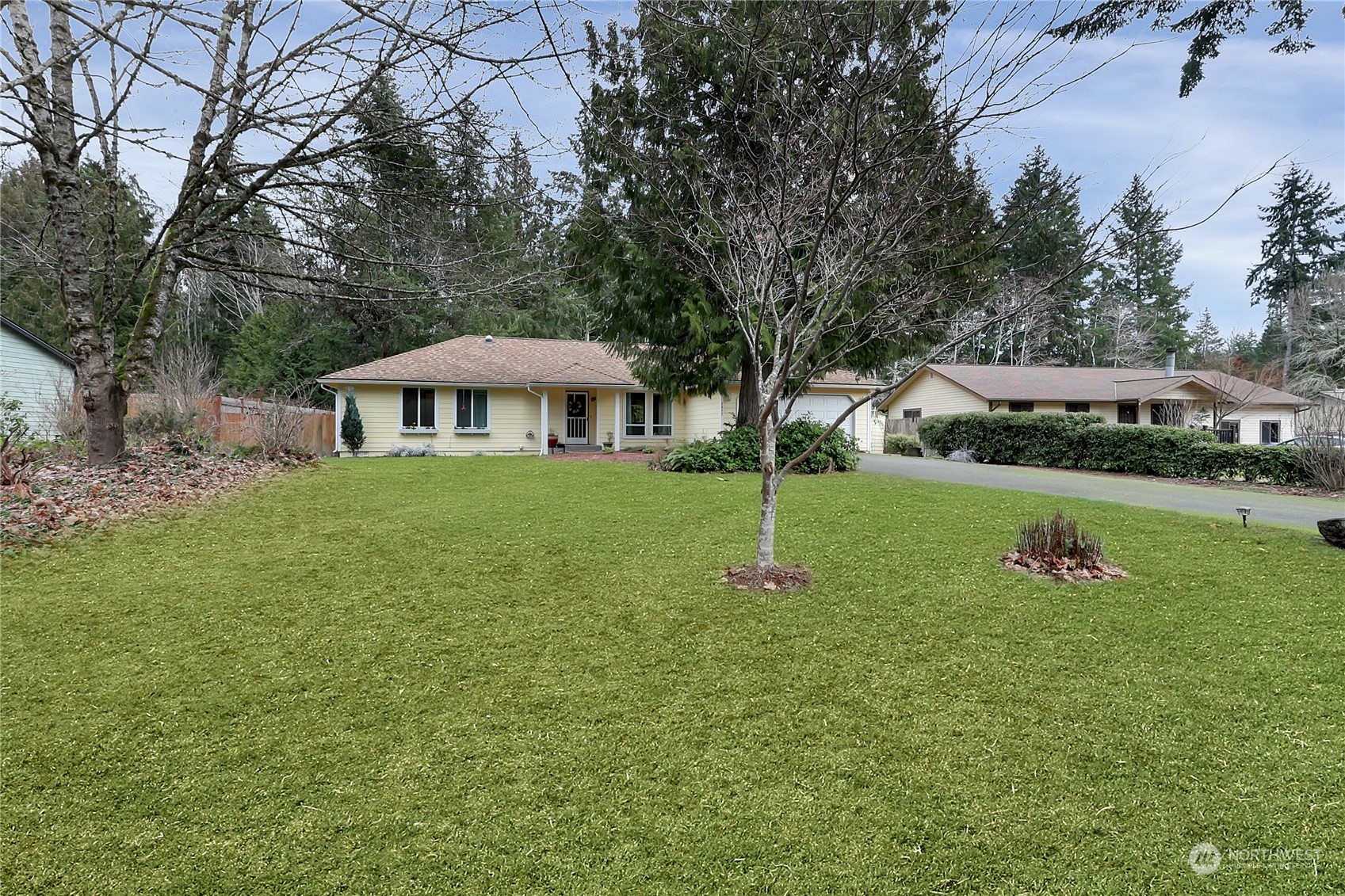 7455 Glacier Ridge Place Southeast Port Orchard, WA 98367 - Photo 2 of 32 a view of a house with a yard