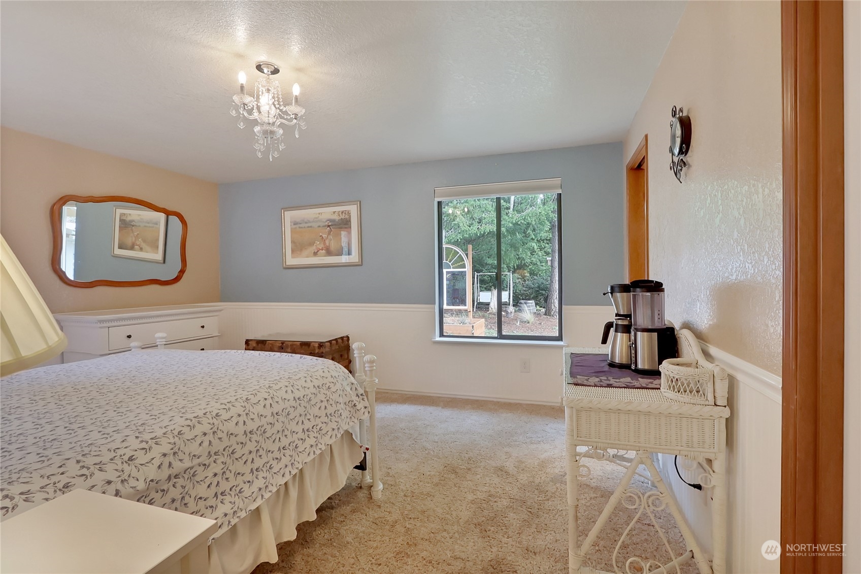 7455 Glacier Ridge Place Southeast Port Orchard, WA 98367 - Photo 21 of 32 a bedroom with a bed and a chandelier