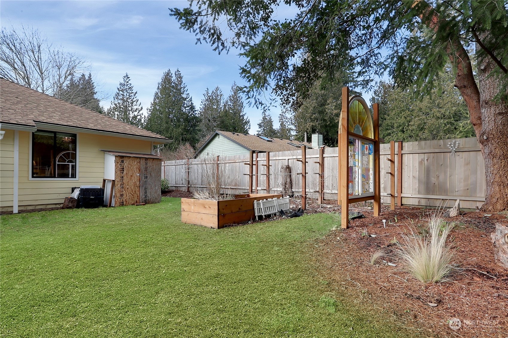 7455 Glacier Ridge Place Southeast Port Orchard, WA 98367 - Photo 26 of 32 a view of a house with backyard and a tree