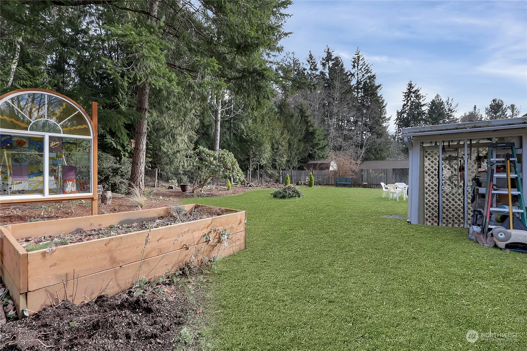 7455 Glacier Ridge Place Southeast Port Orchard, WA 98367 - Photo 27 of 32 a view of a house with backyard and sitting area