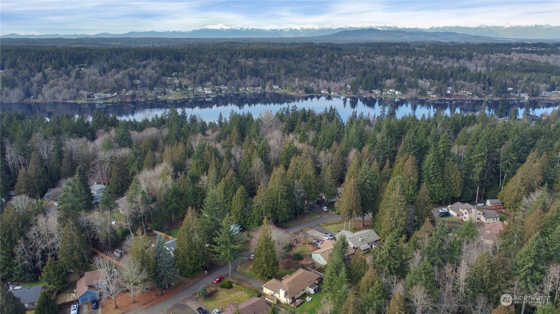 7455 Glacier Ridge Place Southeast Port Orchard, WA 98367 - Photo 30 of 32 a view of a lake with mountains in the background