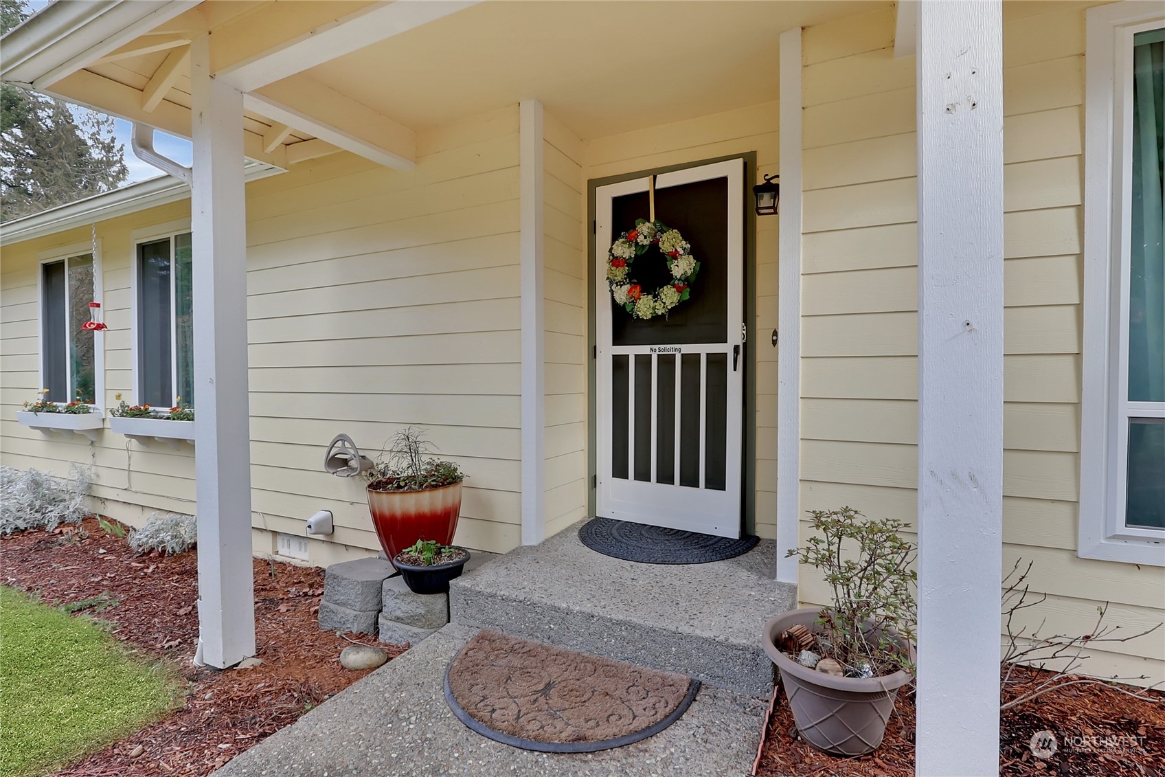 7455 Glacier Ridge Place Southeast Port Orchard, WA 98367 - Photo 5 of 32 a backyard of a house with dining table and chairs