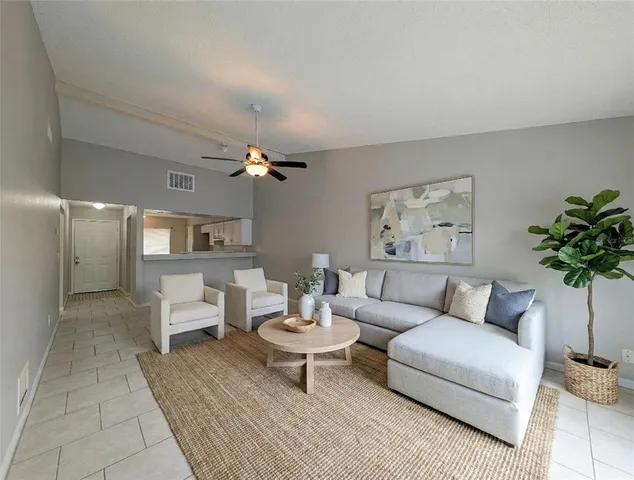 a living room with furniture and a potted plant