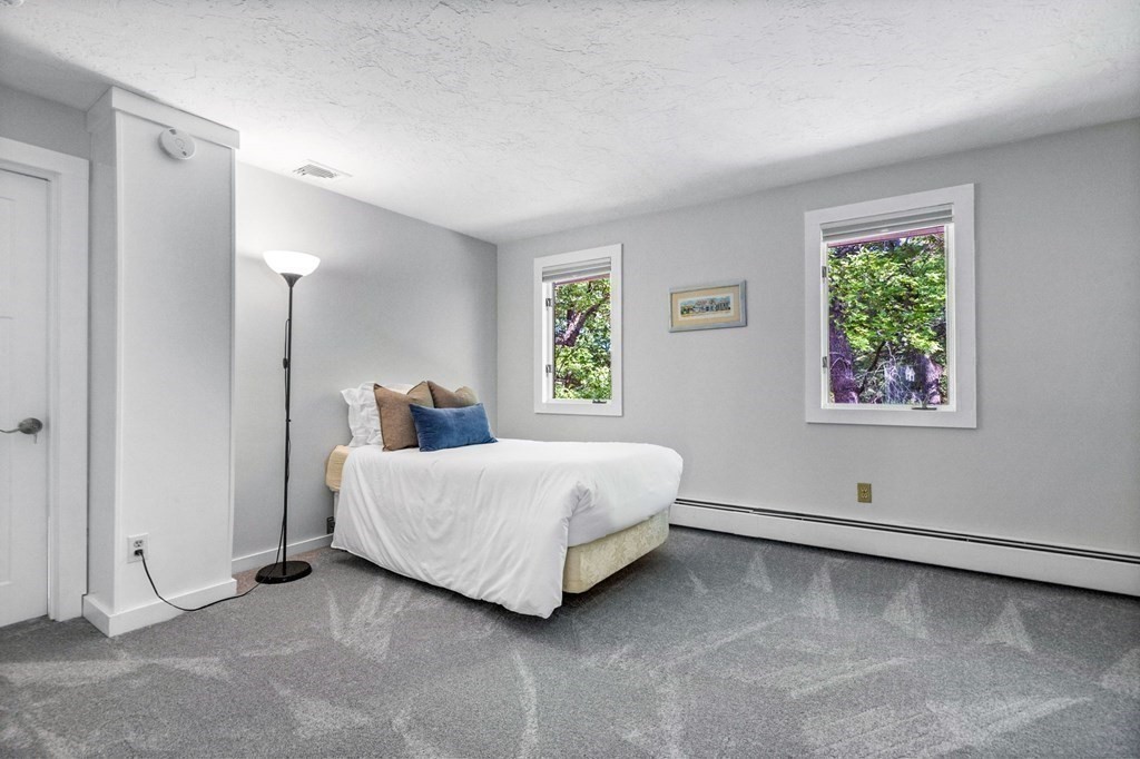 142 Ward Street Hingham, MA 02043 - Photo 19 of 41 a spacious bedroom with a bed and a window