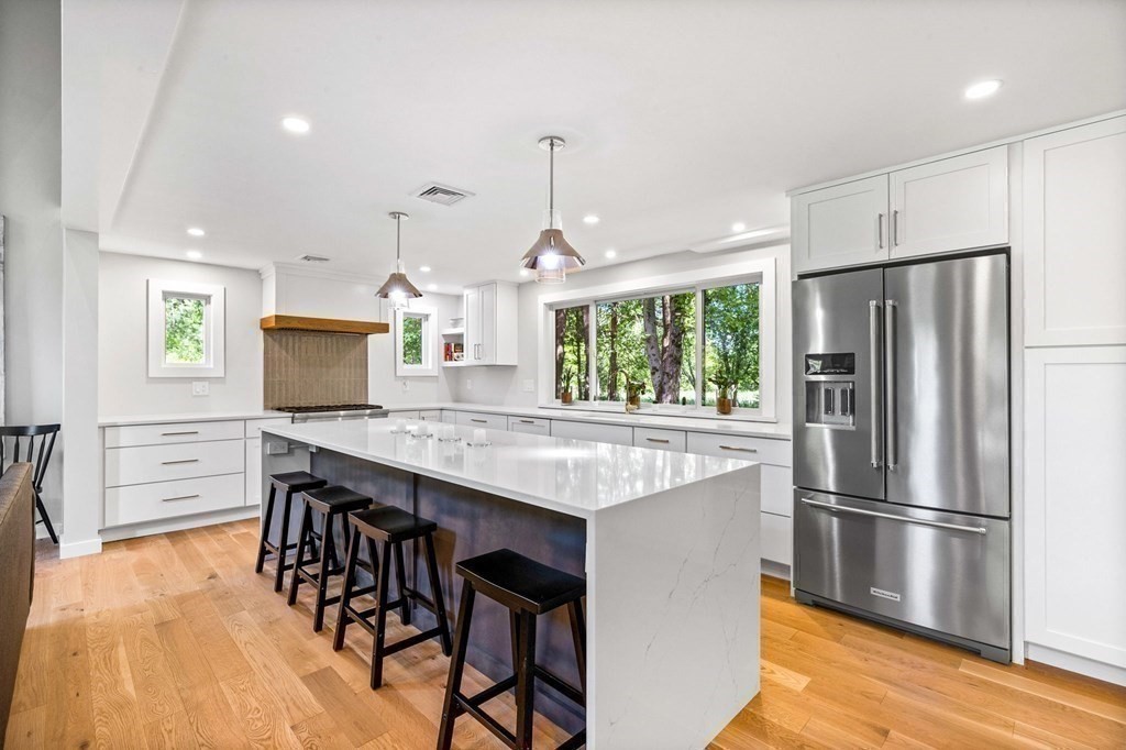 142 Ward Street Hingham, MA 02043 - Photo 2 of 41 a kitchen with stainless steel appliances a dining table chairs refrigerator and stove