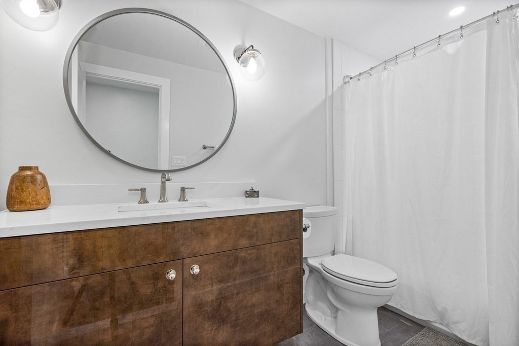 142 Ward Street Hingham, MA 02043 - Photo 25 of 41 a bathroom with a sink mirror vanity and toilet