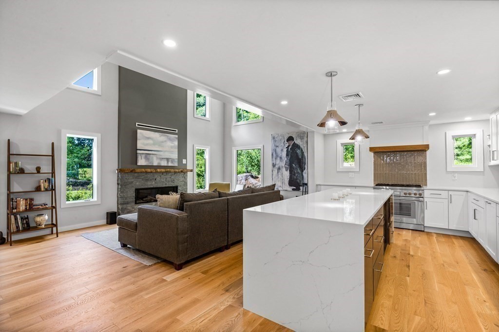 142 Ward Street Hingham, MA 02043 - Photo 4 of 41 a living room with fireplace furniture and a flat screen tv