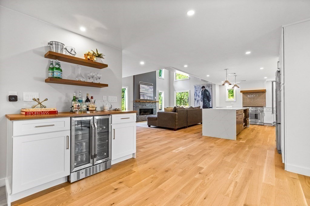 142 Ward Street Hingham, MA 02043 - Photo 5 of 41 a view of a kitchen with kitchen island stainless steel appliances a stove a sink dishwasher and a refrigerator with wooden floor