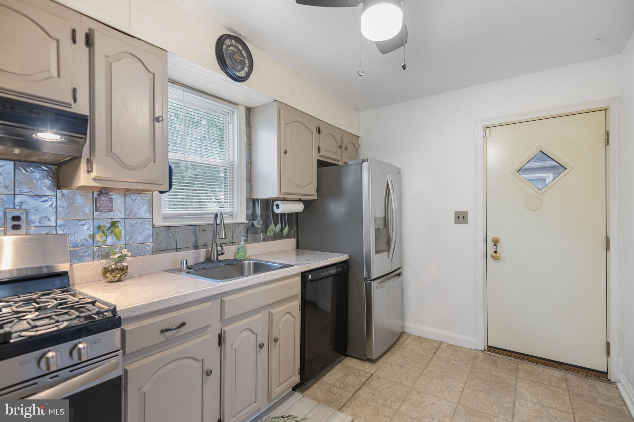 6402 Moyer Avenue Baltimore, MD 21206 - Photo 11 of 35 a kitchen with stainless steel appliances granite countertop a sink a stove and a refrigerator