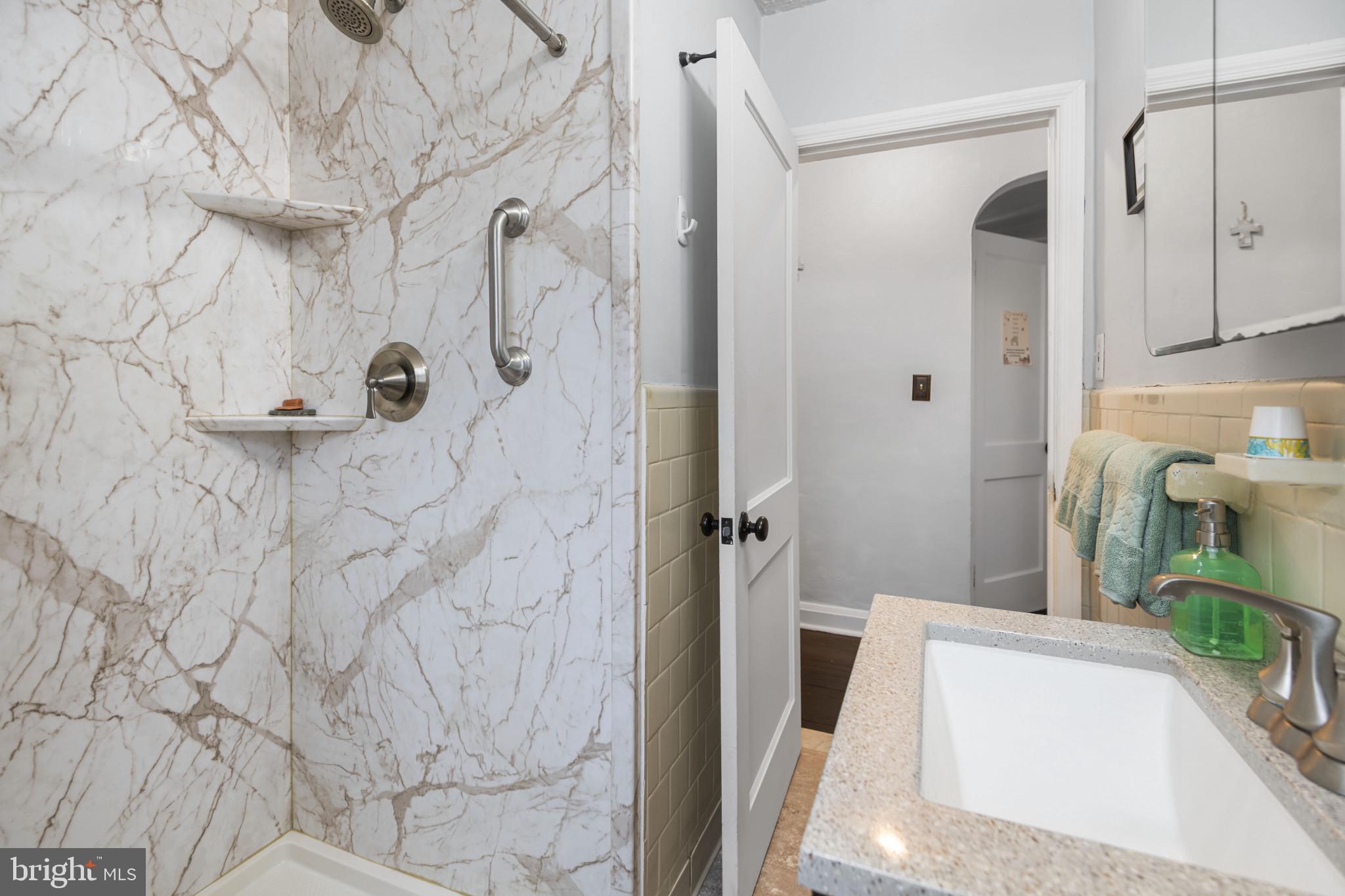 6402 Moyer Avenue Baltimore, MD 21206 - Photo 18 of 35 a bathroom with a tub and a shower