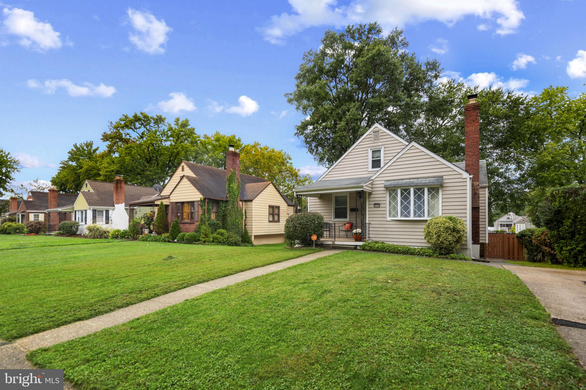 6402 Moyer Avenue Baltimore, MD 21206 - Photo 2 of 35 a front view of a house with a garden and trees