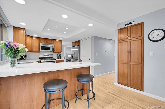 a kitchen with stainless steel appliances granite countertop a stove sink and microwave