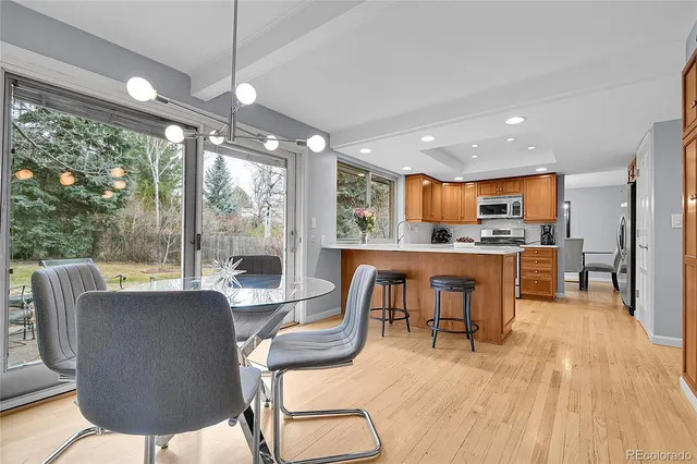 a living room with fireplace furniture and a floor to ceiling window
