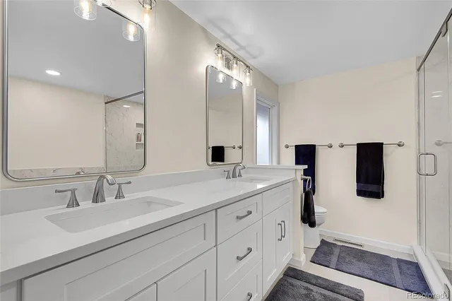 a bathroom with a tub a sink and glass door