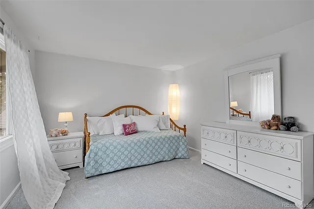 a bed room with a bed and a window