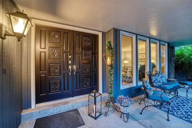 a living room with furniture and floor to ceiling window