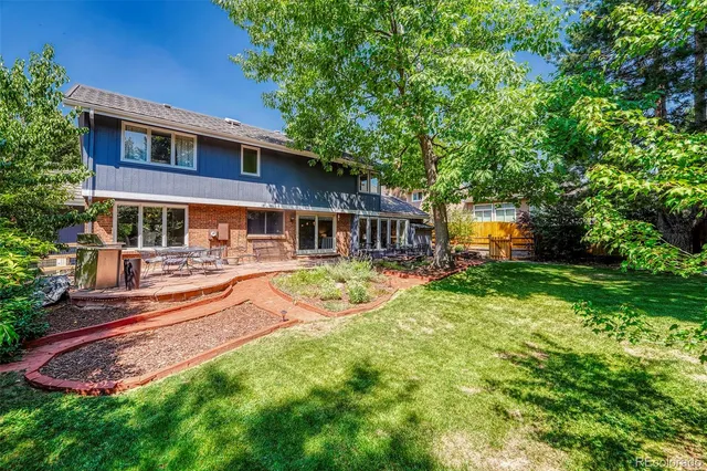 a front view of a house with a yard table and chairs