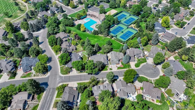 an aerial view of a house with a yard and trees