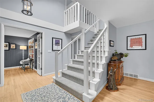 a view of entryway and hall with wooden floor