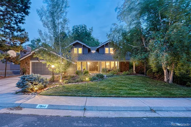 a view of a patio with table and chairs potted plants and floor to ceiling window