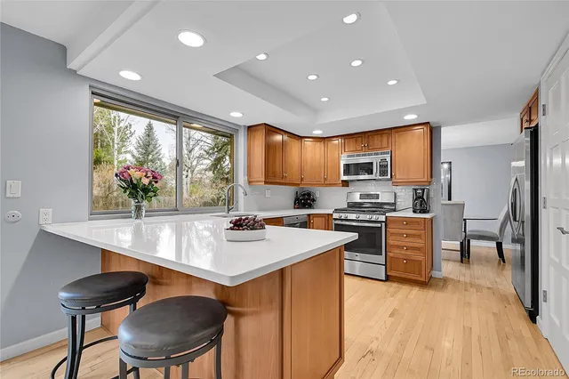 a kitchen with stainless steel appliances granite countertop a sink refrigerator stove microwave and cabinets
