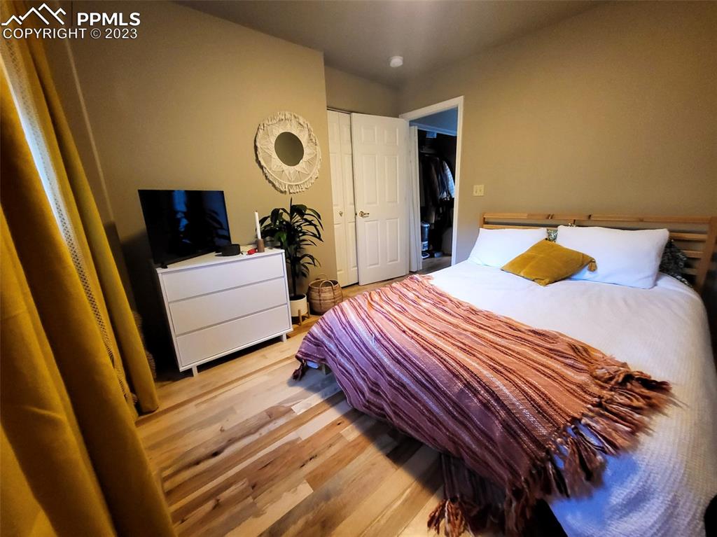 4440 Prairie Street Cascade, CO 80809 - Photo 16 of 31 a bedroom with a bed and a walk in closet