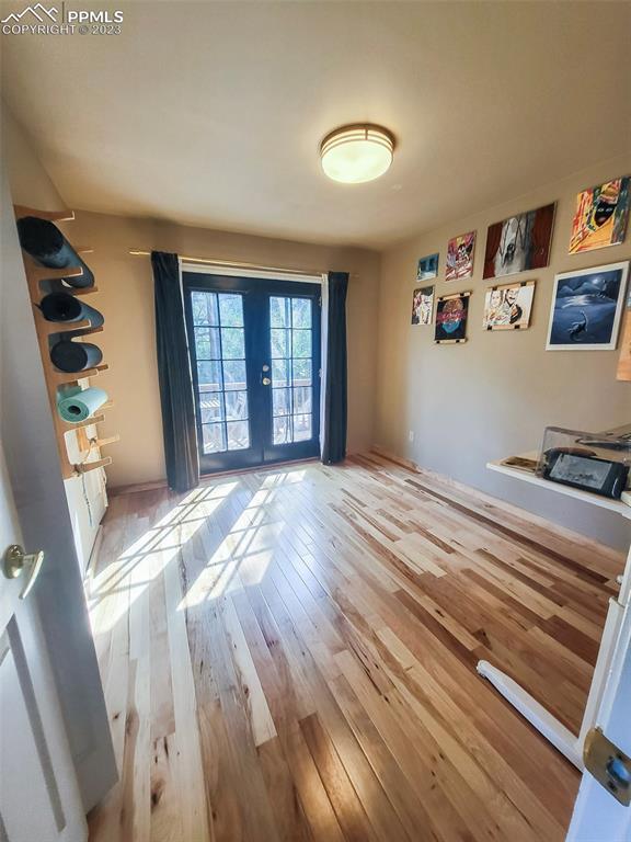 4440 Prairie Street Cascade, CO 80809 - Photo 17 of 31 a view of a bedroom with wooden floor and window