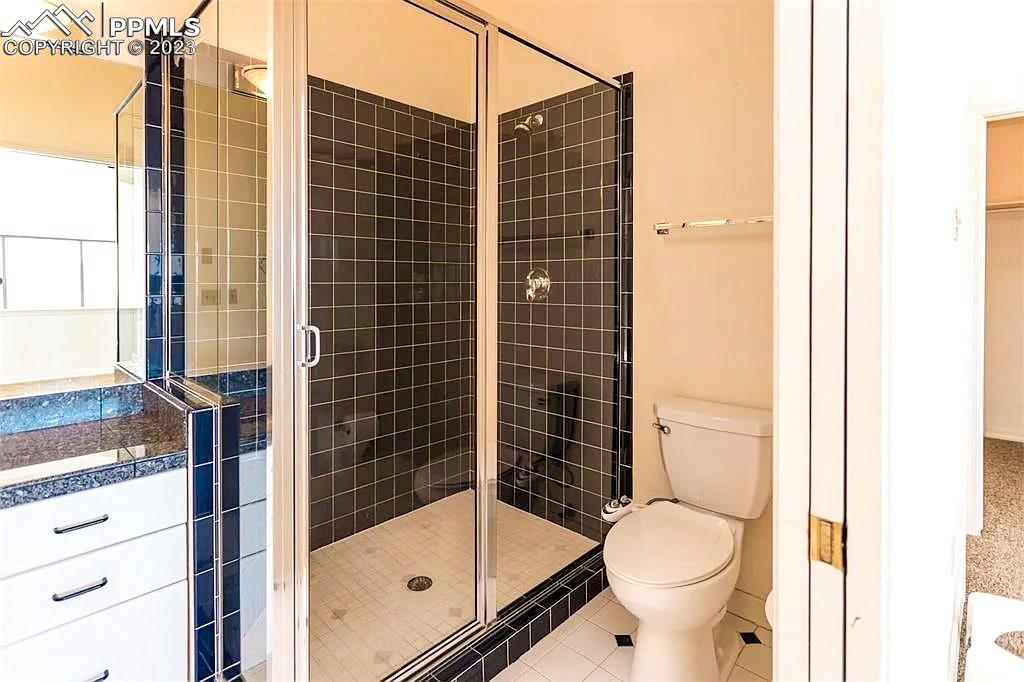 4440 Prairie Street Cascade, CO 80809 - Photo 25 of 31 a bathroom with a shower toilet and sink