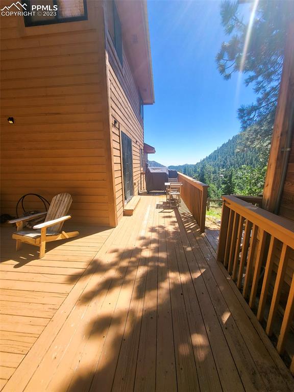 4440 Prairie Street Cascade, CO 80809 - Photo 4 of 31 a view of a balcony with wooden floor
