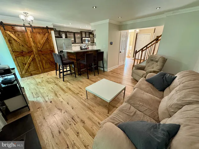 a living room with furniture a dining table and a piano