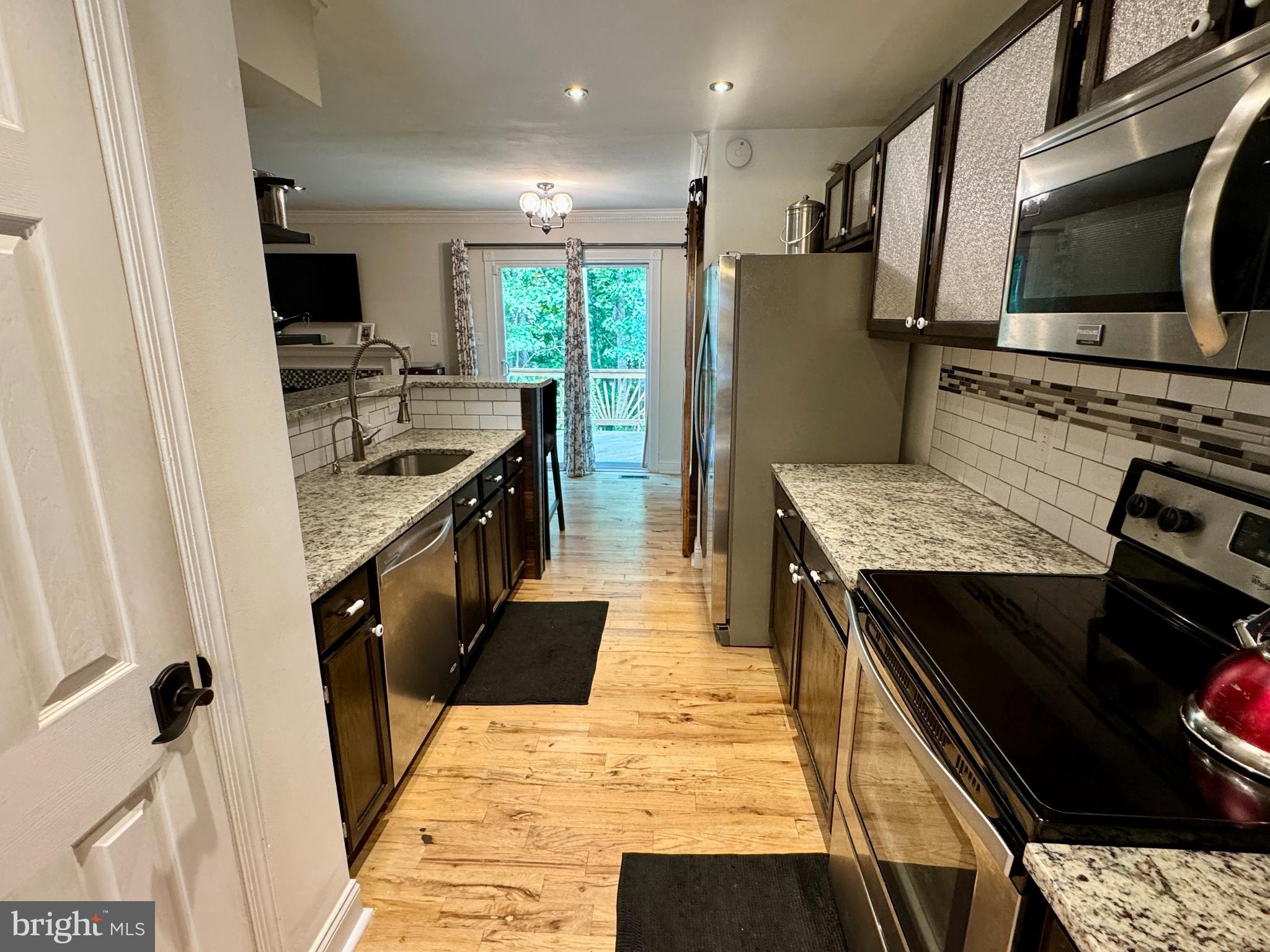903 Wind Ridge Drive Stafford, VA 22554 - Photo 6 of 34 a kitchen with stainless steel appliances granite countertop a table and chairs