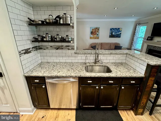 a kitchen with granite countertop a sink and a stove