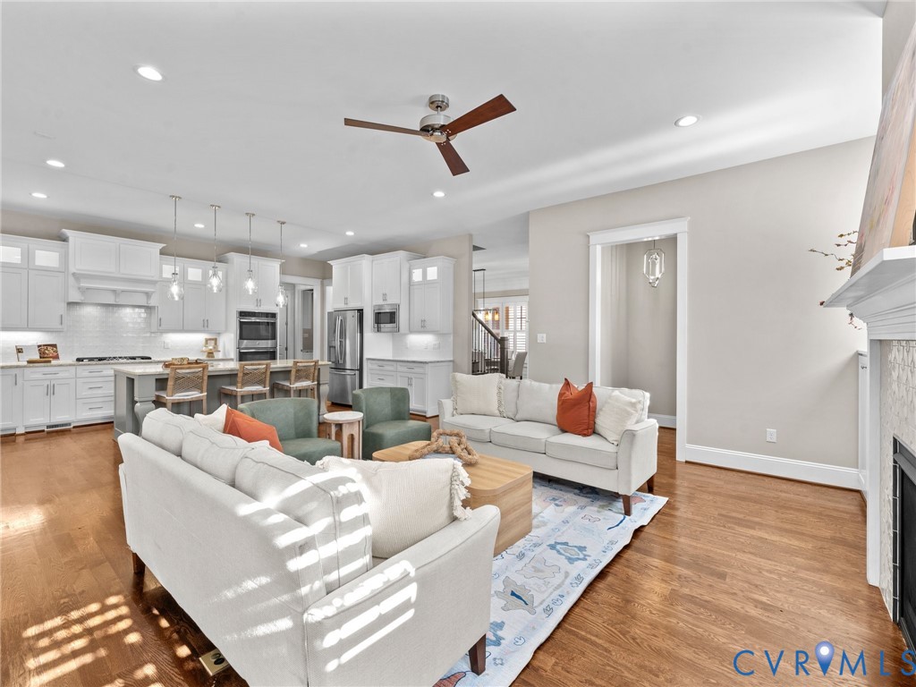 16125 Binley Road Midlothian, VA 23112 - Photo 16 of 50 a living room with furniture kitchen view and a wooden floor
