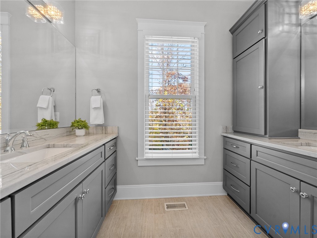 16125 Binley Road Midlothian, VA 23112 - Photo 28 of 50 a bathroom with a granite countertop sink and a mirror