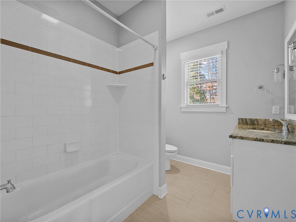 16125 Binley Road Midlothian, VA 23112 - Photo 34 of 50 a bathroom with a granite countertop sink a toilet and shower