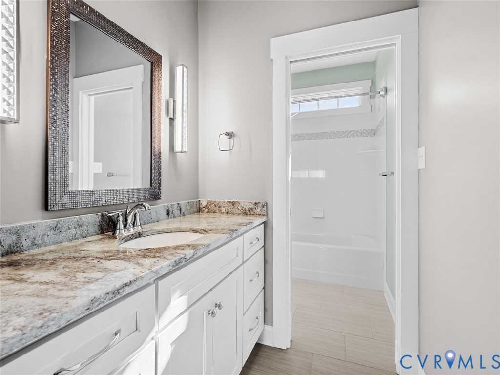16125 Binley Road Midlothian, VA 23112 - Photo 37 of 50 a bathroom with a granite countertop sink and a mirror